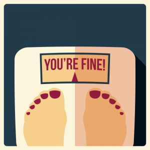 A picture of a bathroom scale showing the words, "You're Fine!"